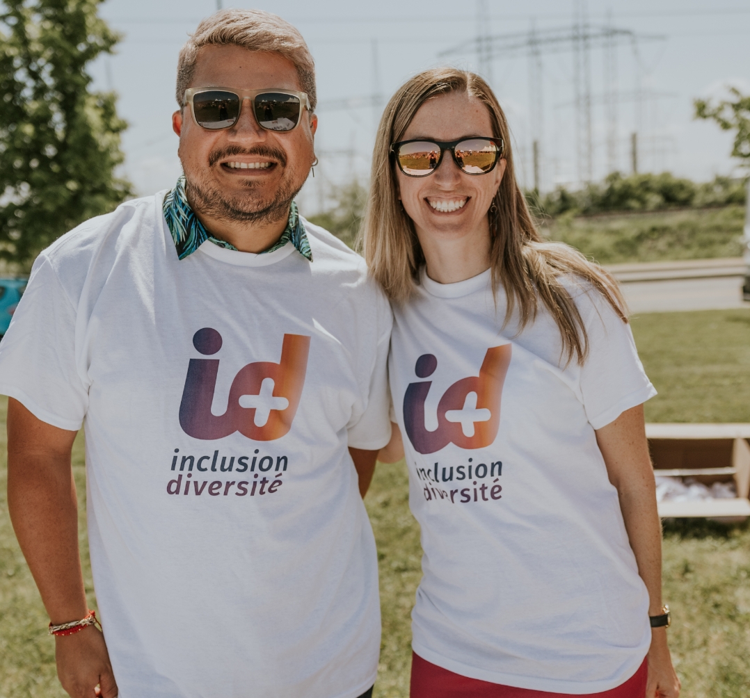 2 people wearing a t-shirt that promotes Equity, diversity and inclusion